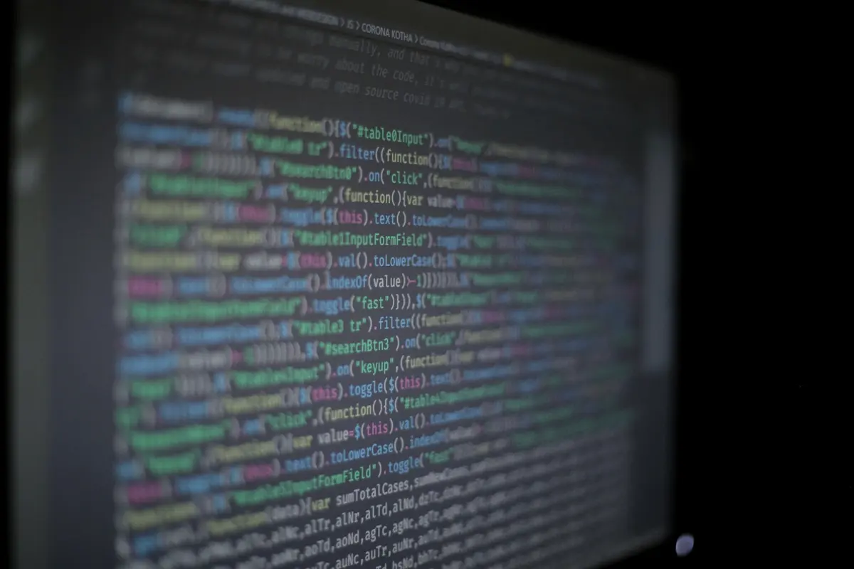 Source code on a monitor in a dark room.