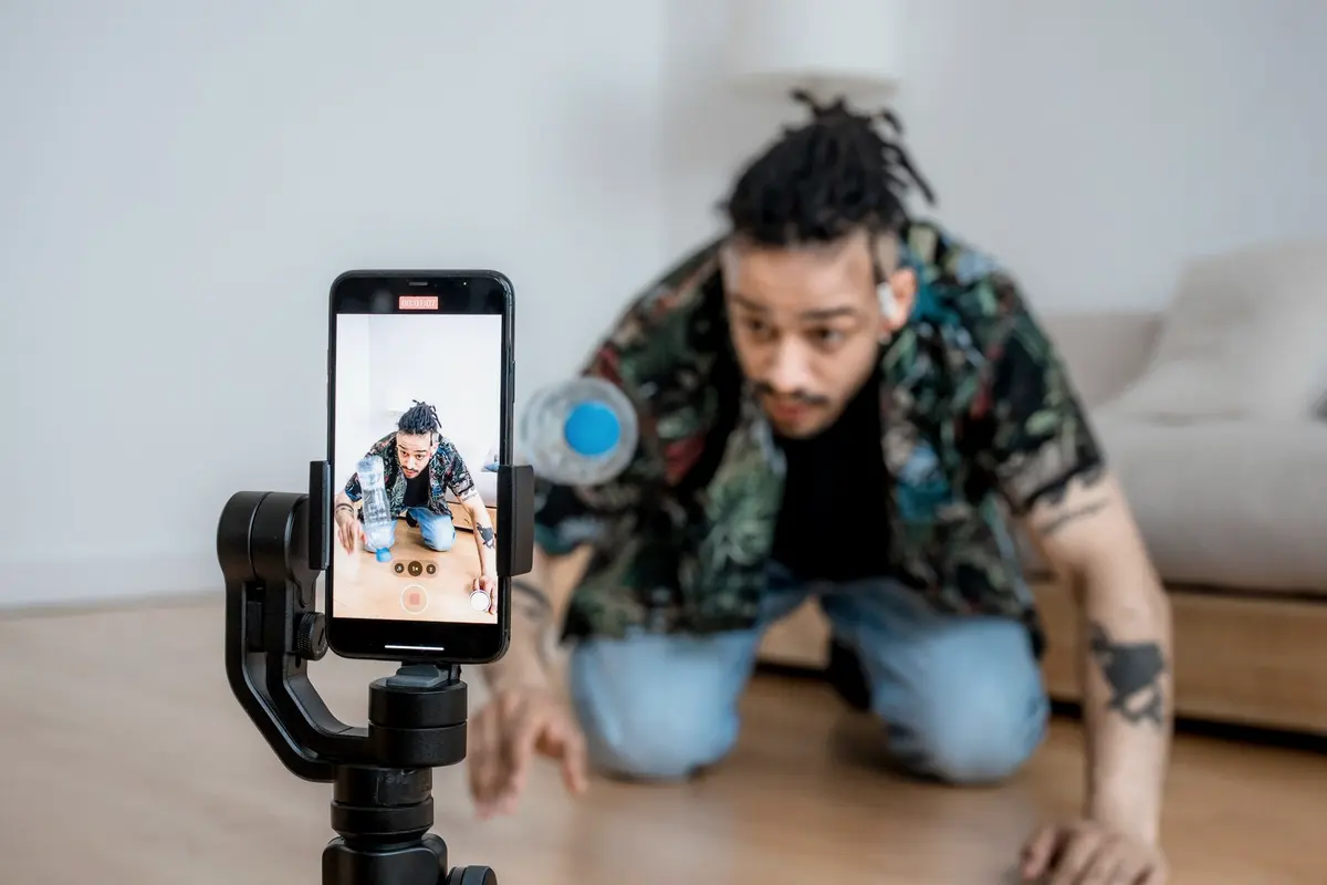 A creator filming himself on a phone mounted on a gimbal.